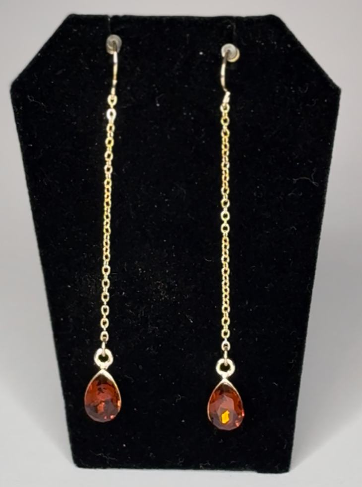 Gold earrings with amber stones.