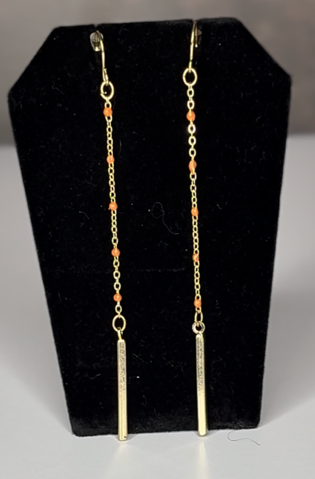 Gold thread earrings with small orange beads and a golden bar drop